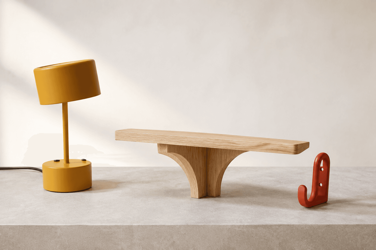 Illustrative homeware collection: a yellow studio lamp, pale oak arc shelf, and red loop hook.